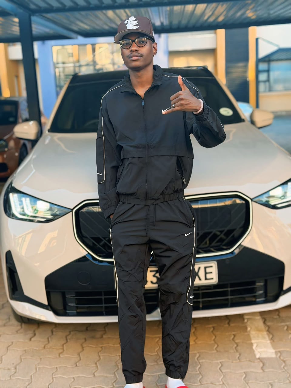 Skud, founder of SkuD Turbo, standing in front of his car